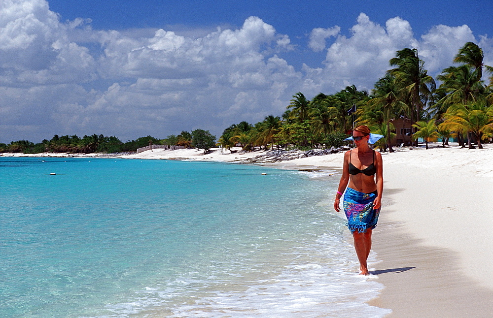 Woman walks on sandy beach, Punta Cana, Caribbean, Dominican Republic