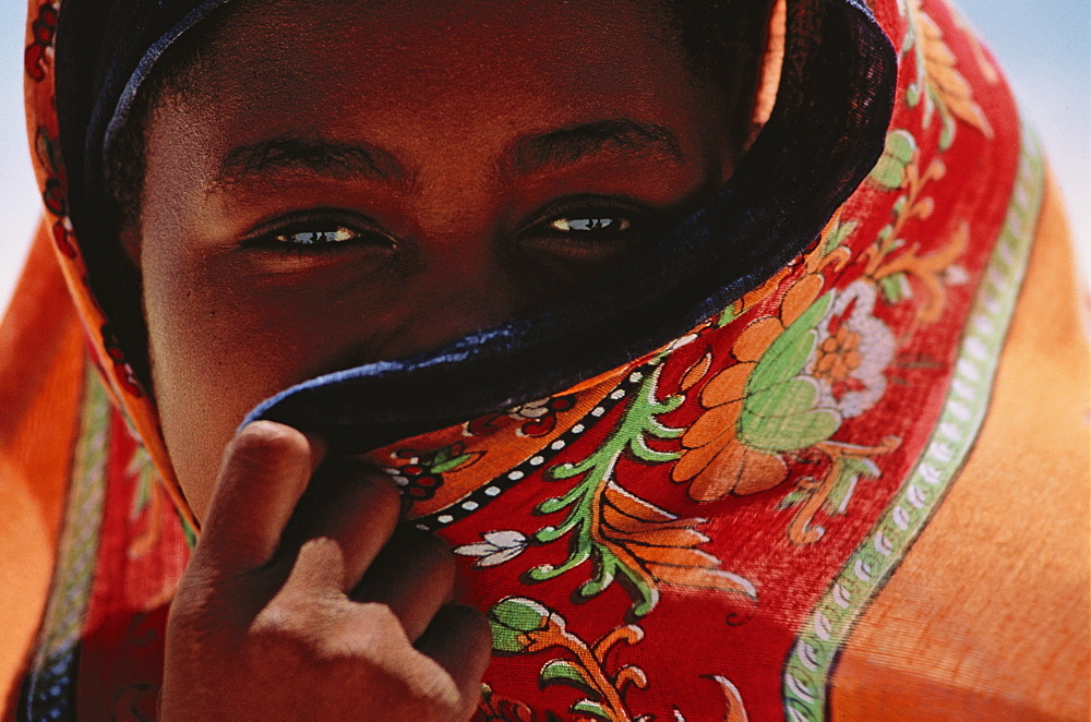 Muslim girl behind colorful veil, Bwejuu, Unguja, Zanzibar, Tanzania, Africa