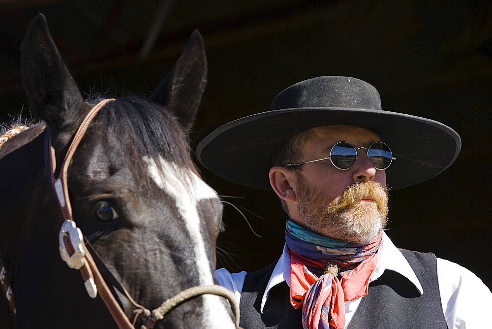 cowboy with horse at stable, wildwest, Oregon, USA