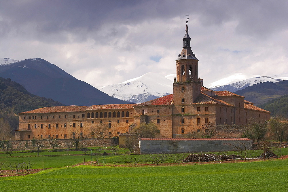 Snow topped mountain range, Sierra de la Demanda, behind a monastery, Monasterio de Yuso, San Millan de la Cogolla, La Rioja, Spain