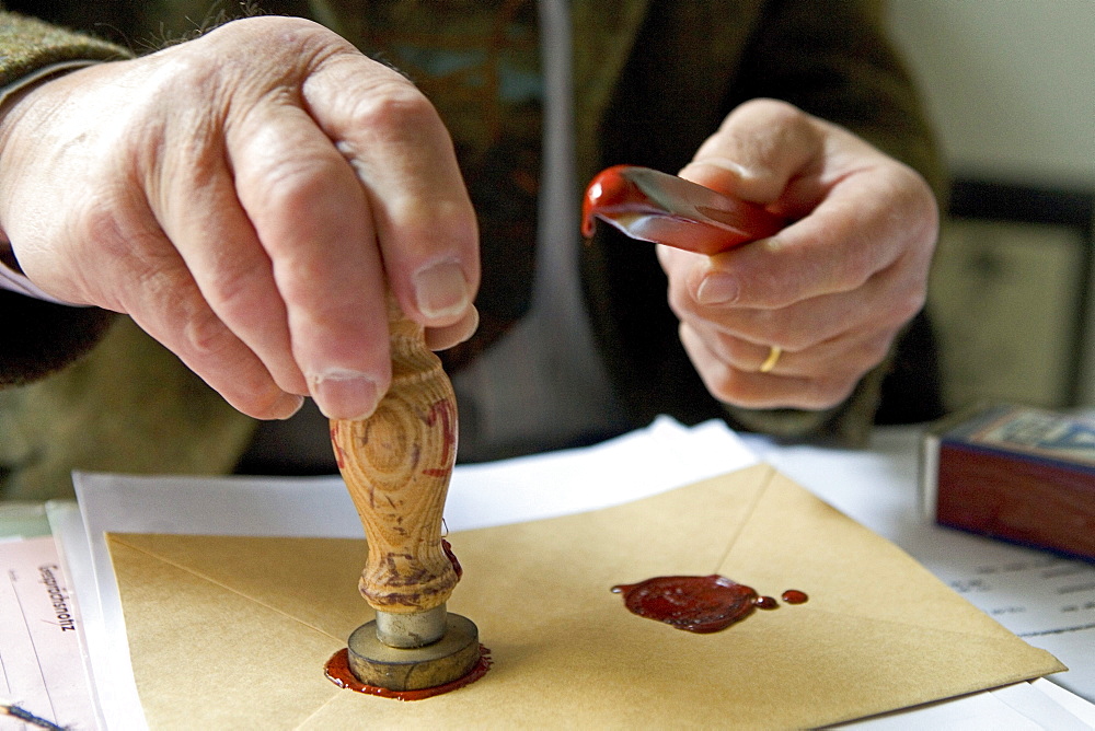 Notary fixes a seal on a document, last will and testament, inheritance seal, sealing wax