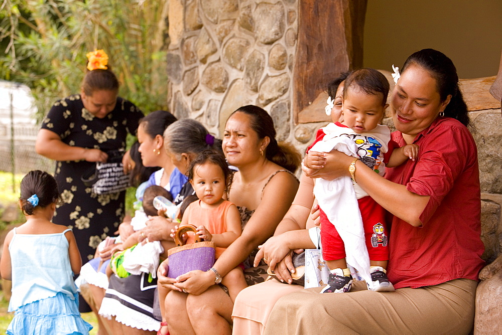 Women and children sitting in front of the church, Nuku Hiva, Marquesas Islands, Polynesia, Oceania