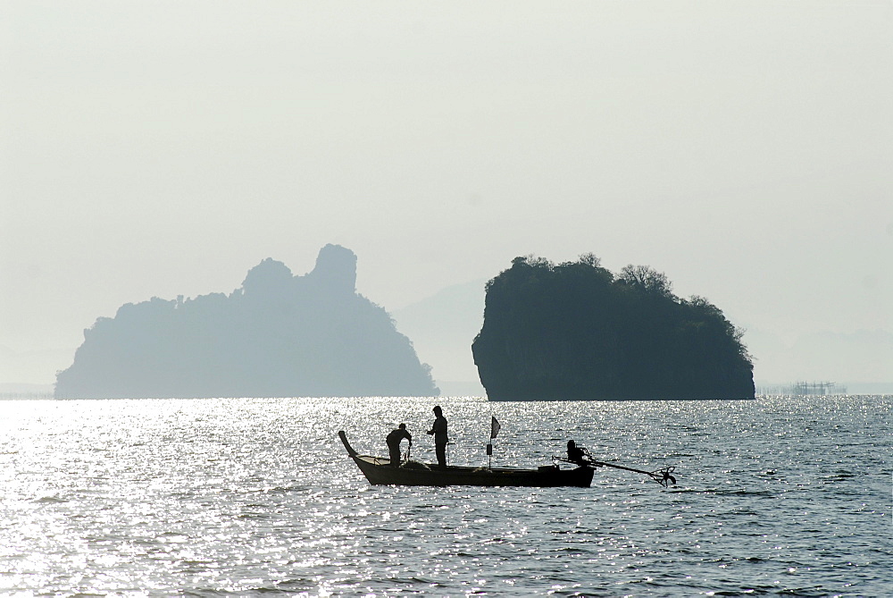 Fischermen in a small boat, south of Ko Lanta, Krabi, Thailand