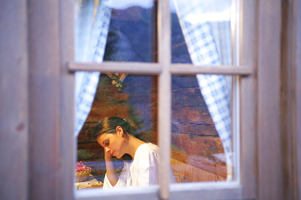 Woman in alp lodge, Heiligenblut, Hohe Tauern National Park, Carinthia, Austria