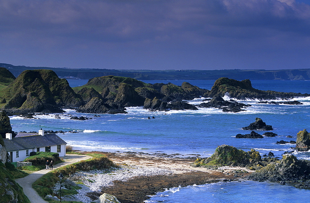 House on shore under clouded sky, County Antrim, Ireland, Europe