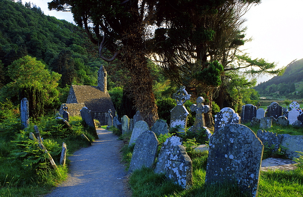 Old church and graveyard under some trees, Glendalough, Wicklow Mountains, County Wicklow, Ireland, Europe