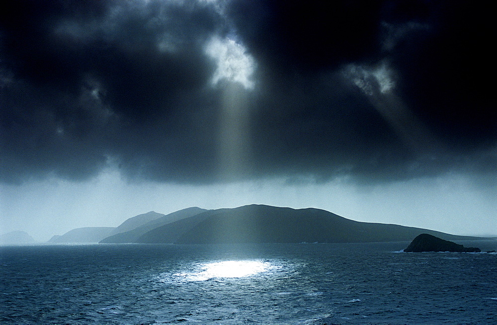 Sunbeams shining through dark cloud cover at Dingle Bay, Great Blasket Island, County Kerry, Ireland, Europe