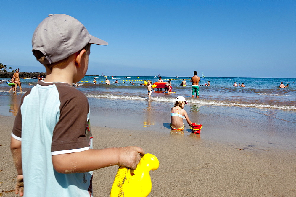 Boy on the beach, Playa de Cucharas, Costa Teguise, Lanzarote, Canary Islands, Spain, Europe