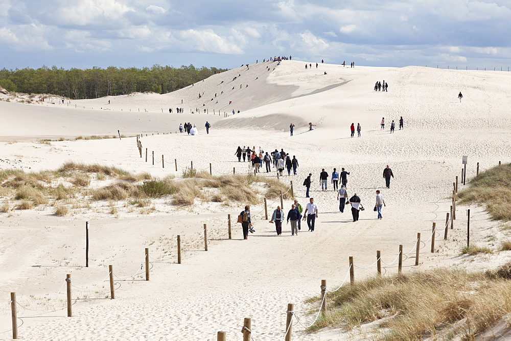 Tourists walking in the dunes, UNESCO World Biosphere Reserve, Slowinski National Park, Polish Baltic Sea coast, Leba, Pomeranian, Poland