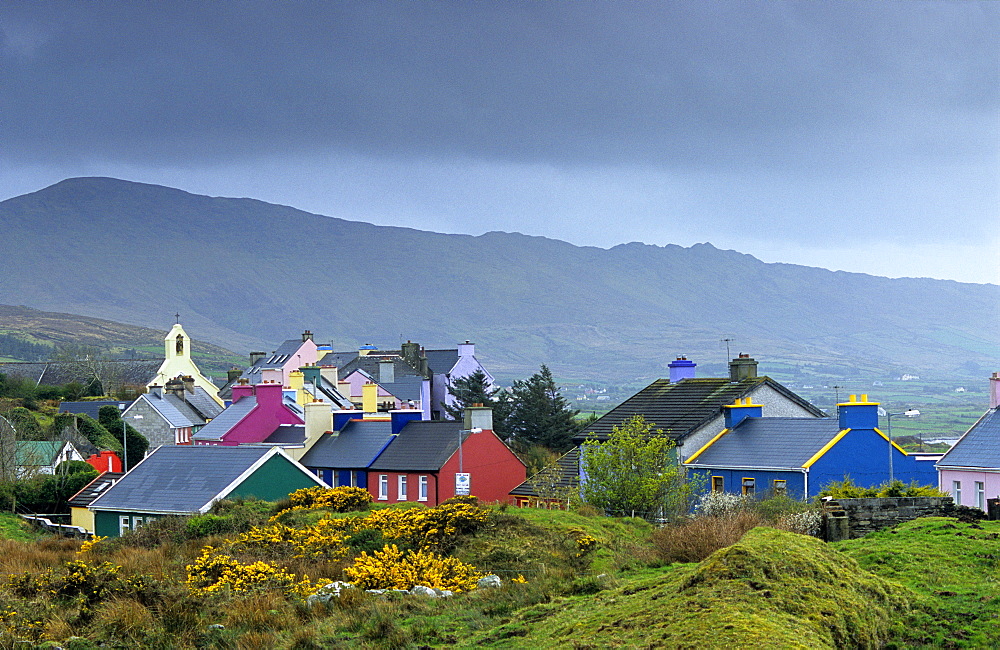 Colourful houses under grey clouds, Eyeries, Beara peninsula, County Cork, Ireland, Europe