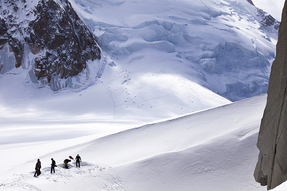 Mountaineers pitching base camp, View towards Mont Blanc du Tacul, Chamonix, Mont-Blanc, France