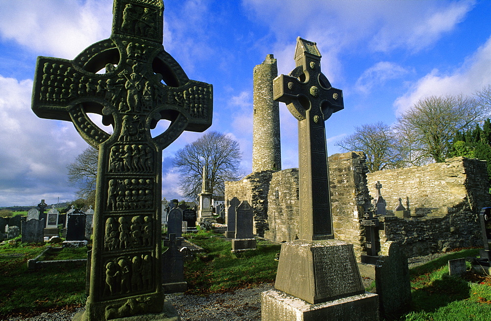 High crosses in front of the ruins of Monasterboice abbey under clouded sky, County Louth, Ireland, Europe