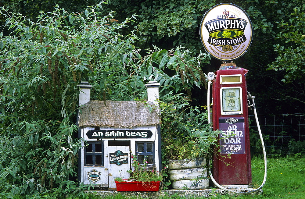 Old gas station, petrol station with Murphys beer sign on top near a pub in Lauragh on the Ring of Beara, County Kerry, Ireland, Europe