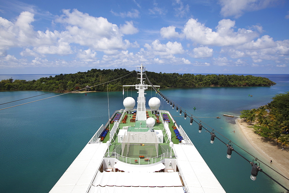 Pool and deck of cruise ship MS Deutschland (Reederei Peter Deilmann) and narrow harbor entrance, Port Antonio, Portland, Jamaica, Caribbean