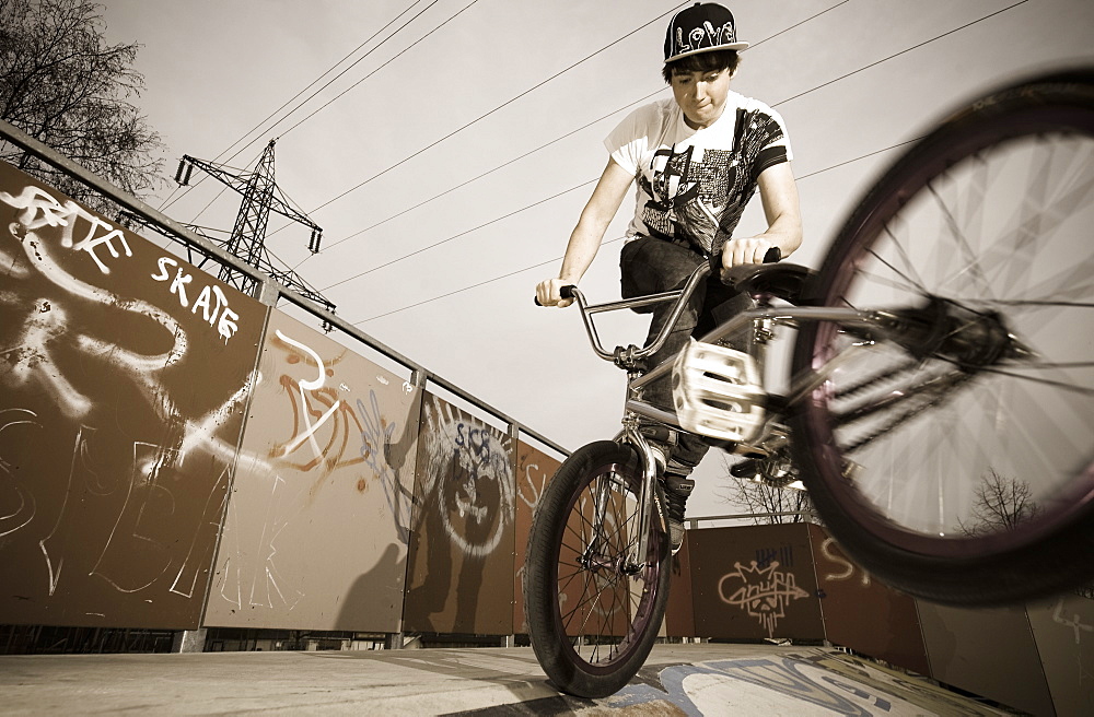 A teenager BMX riding in the evening, Wagram, Austria