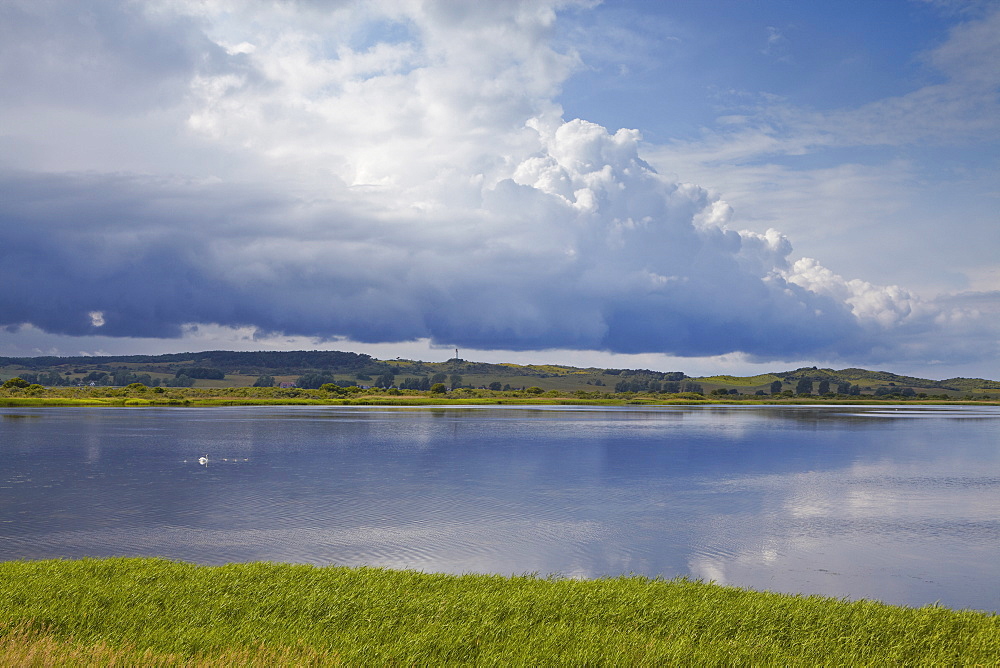 Vitter Bodden and Dornbusch lighthouse under cumulus clouds, Hiddensee Island, Western Pomerania Lagoon Area National Park, Mecklenburg Western Pomerania, Germany, Europe