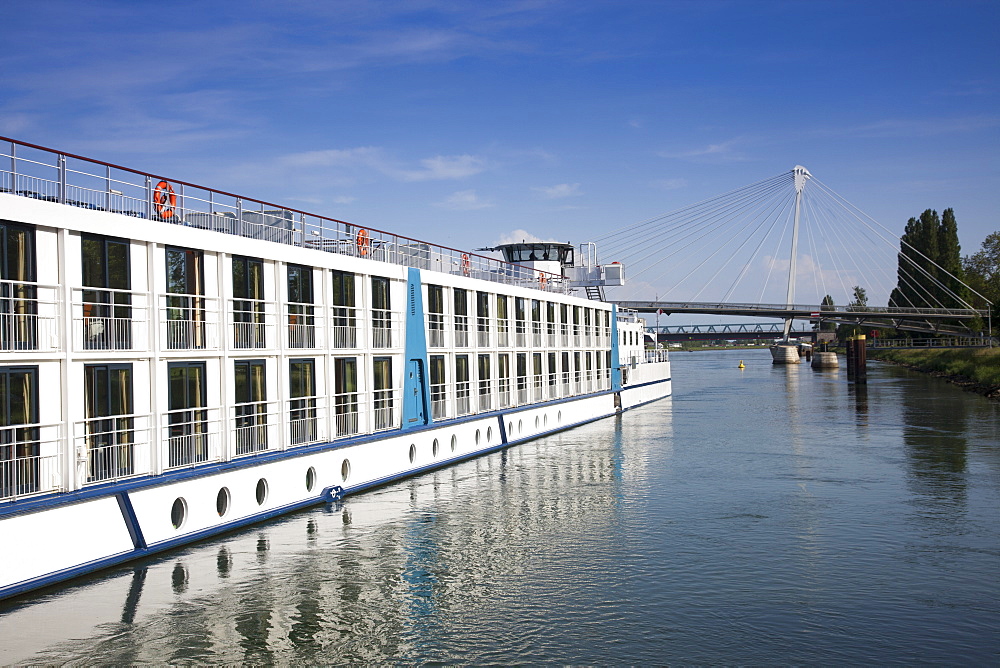 Rhine river cruise ship MS Bellevue and Passerelle des deux Rives pedestrian and cyclist bridge over Rhine river linking Strasbourg in France and Kehl in Germany, Kehl, Baden-Wurttemberg, Germany, Europe