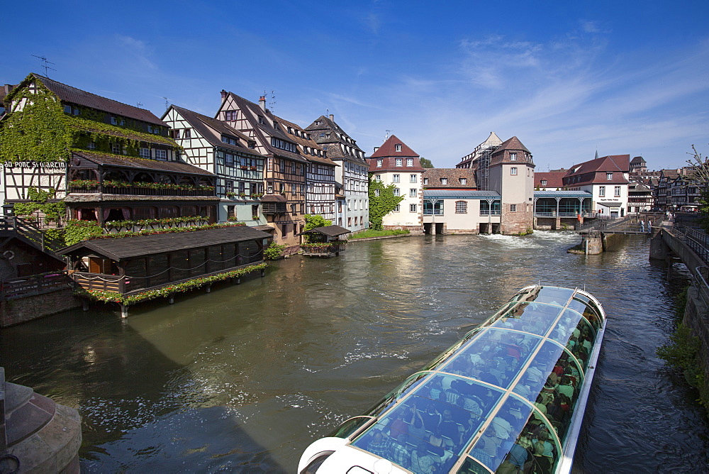 Restaurant Au Pont St. Martin and half-timbered houses and sightseeing boat on canal in La Petite France district, Strasbourg, Alsace, France, Europe