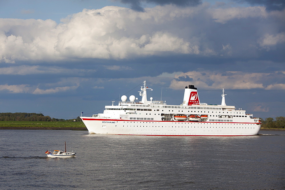 Cruise ship MS Deutschland and small boat on Elbe river, Stade, Lower Saxony, Germany, Europe