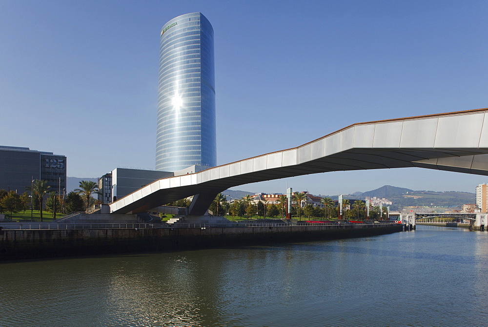 High rise building Torre Iberdrola and bridge Puente Arupe in the sunlight, Rio Nervion river, Bilbao, Province of Biskaia, Basque Country, Euskadi, Northern Spain, Spain, Europe