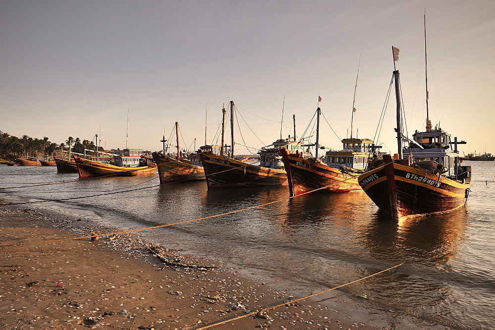 Many colourful fishing boats on the beach of Mui Ne, Vietnam, South China Sea