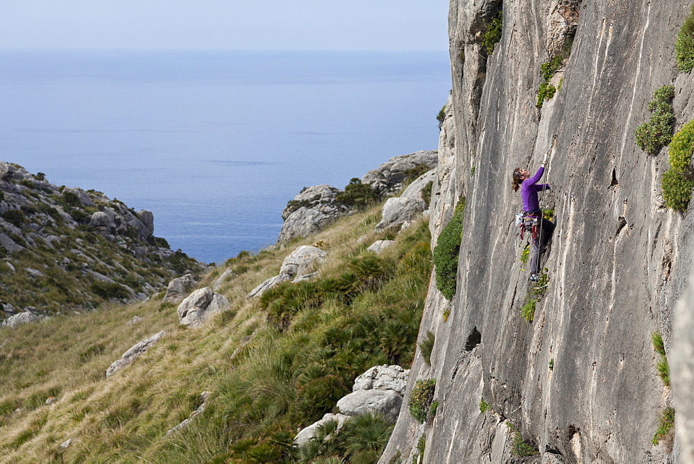 Young women climbing in a steep wall, hiking and climbing on Mallorca, climbing area La Creveta, Cap Formentor, Mediterranean Sea, La Creveta, Cap de Formentor, Serra de Tramuntana, Unesco World Cultural Heritage, Mallorca, Spain