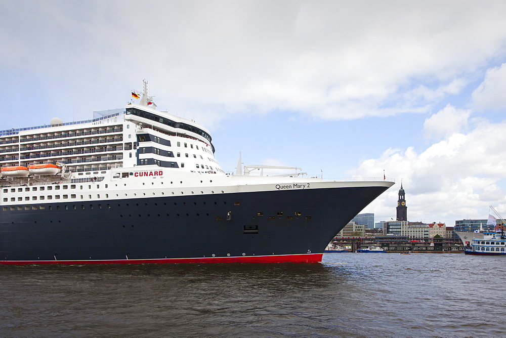 Cruise ship Queen Mary 2 entering port, in front of St Michaelis church, Hamburg, Germany, Europe