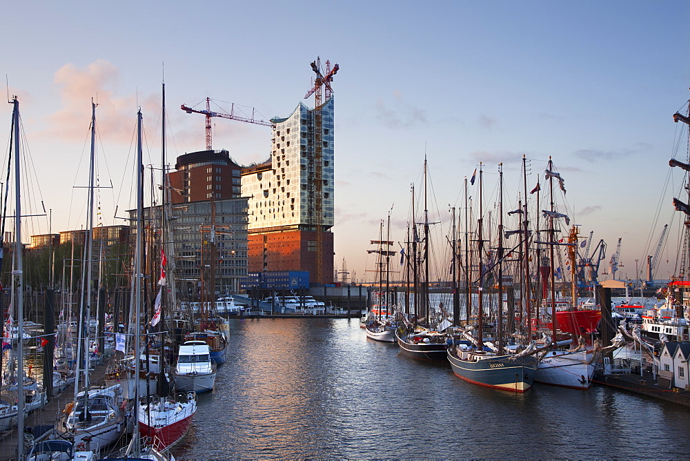 Sailing ships in front of Hafen City and Elbphilharmonie at dusk, Hamburg, Germany, Europe