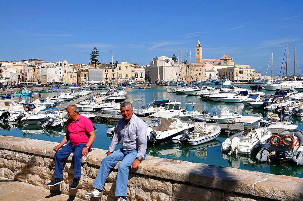 In Trani harbour with Trani Cathedral in the background, Trani, Apulia, Italy