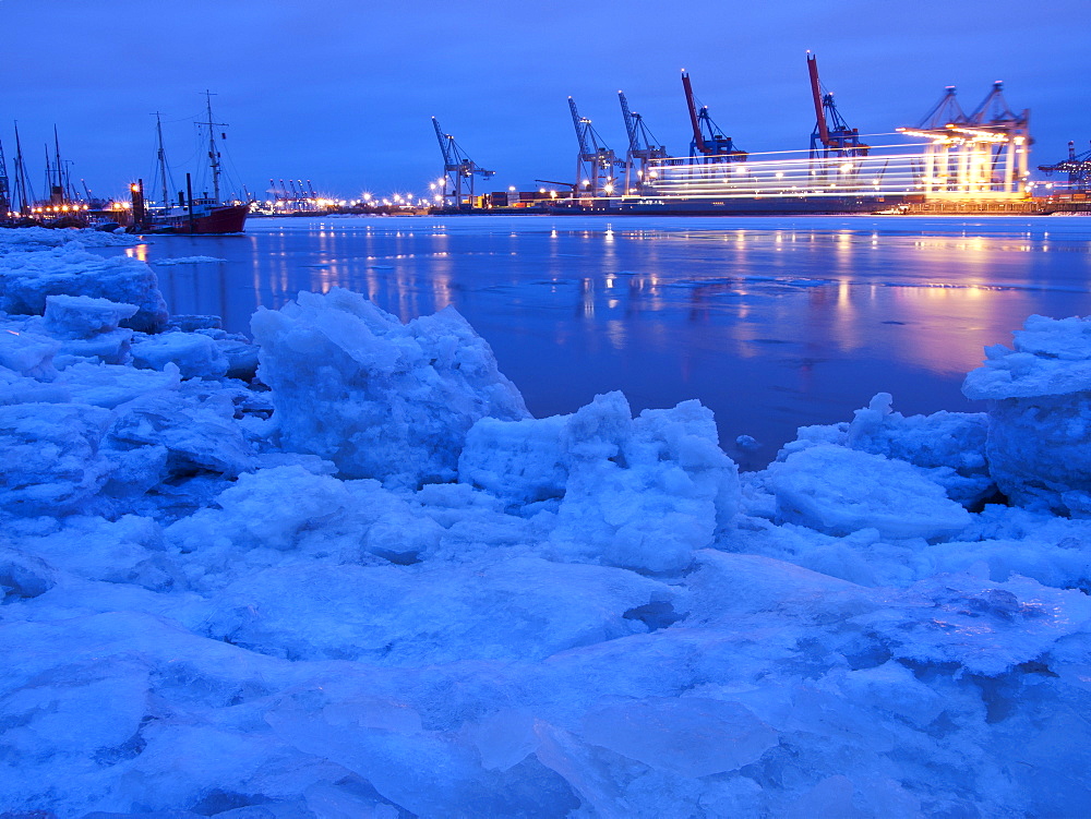 Frozen Elbe river with Waltershof container terminal in the evening, Hanseatic City of Hamburg, Germany, Europe