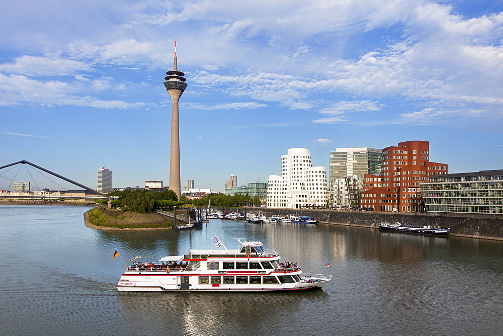 Excursion boat at media harbour, view to Rhine tower and Neuer Zollhof, Duesseldorf, North Rhine-Westphalia, Germany, Europe