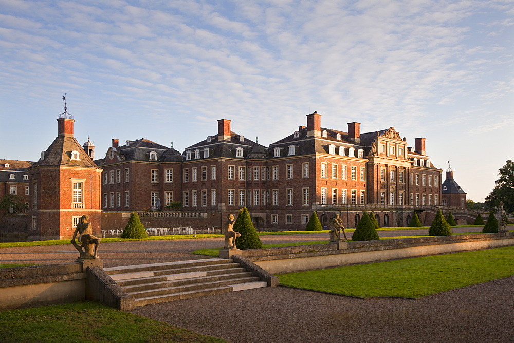 Garden with baroque sculptures at the island of Venus in the evening light, Nordkirchen moated castle, Muensterland, North Rhine-Westphalia, Germany, Europe