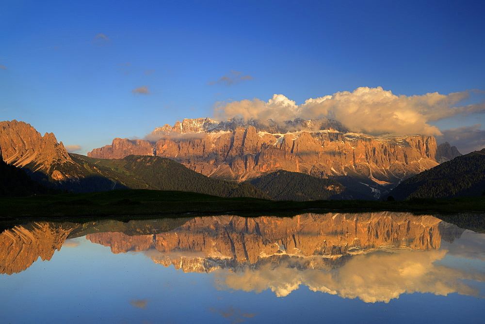 Sella range reflecting in a mountain lake, Val Gardena, Dolomites, UNESCO world heritage site Dolomites, South Tyrol, Italy