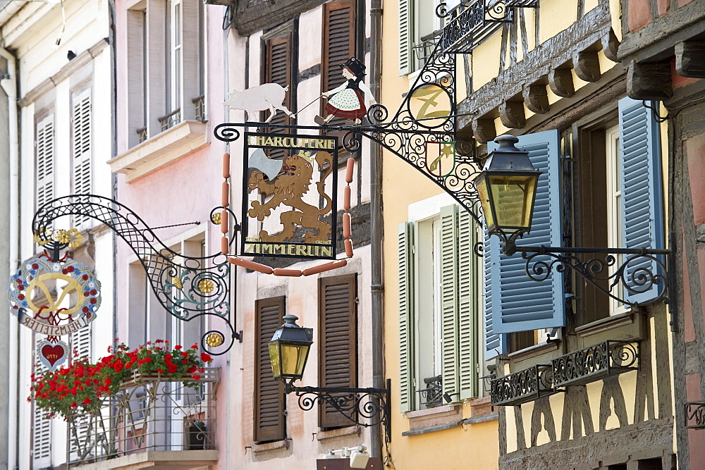 Colourful half timbered houses with decorative wrought-iron signs, Petite Venise, Colmar, Alsace, France