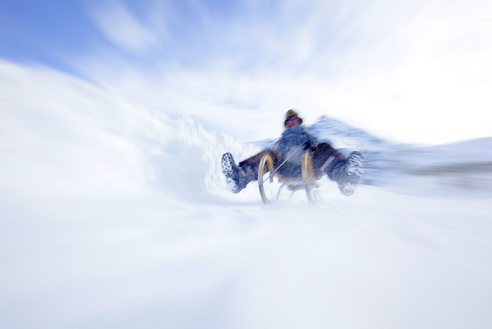 Woman sledding, Kuehtai, Tyrol, Austria