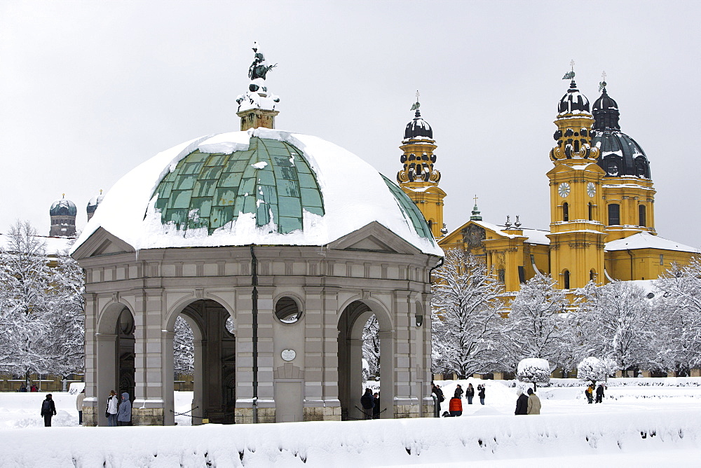 A winter's day at the Hofgarten and its pavillion, the onionshaped towers of the Frauenkirche and the yellow Theatinerkirche, Munich, Bavaria, Germany