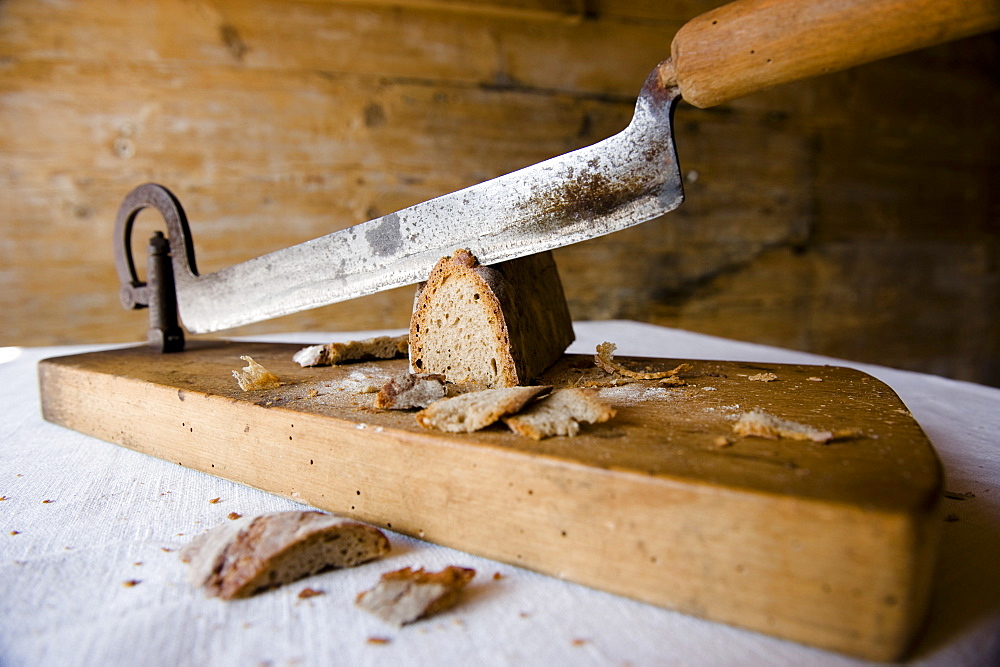 Old bread on a bread slicing machine, baking, homemade