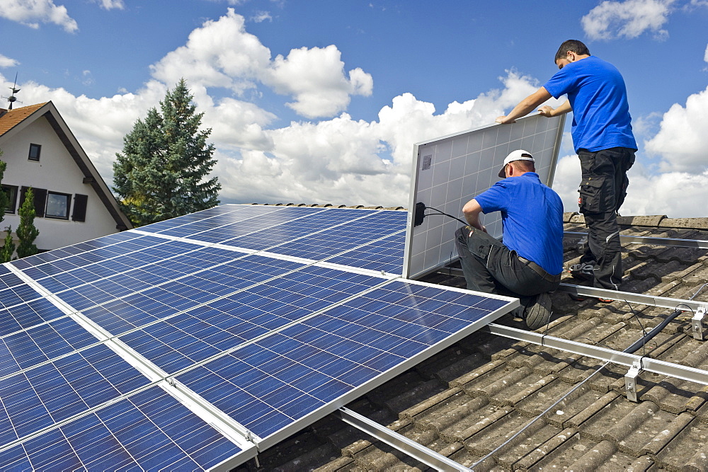 Two persons installing a solar plant, Freiburg im Breisgau, Black Forest, Baden-Wuerttemberg, Germany, Europe