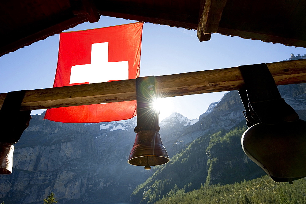 Swiss flag and cow bells at lake Oeschinensee, Kandersteg, Bernese Oberland, Canton of Bern, Switzerland, Europe