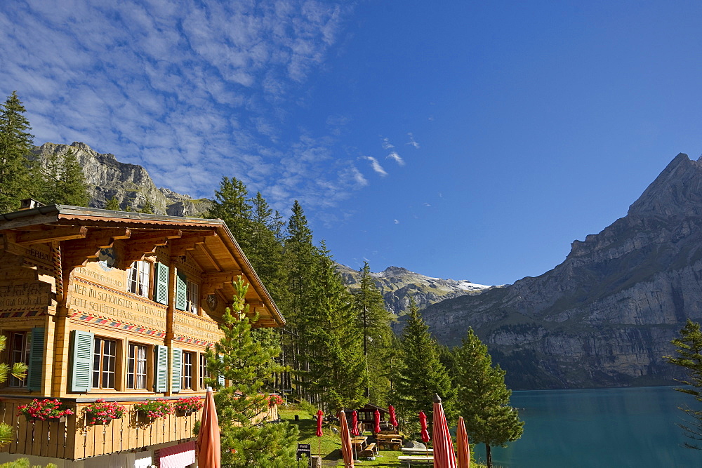 Chalet at lake Oeschinensee in the sunlight, Kandersteg, Bernese Oberland, Canton of Bern, Switzerland, Europe