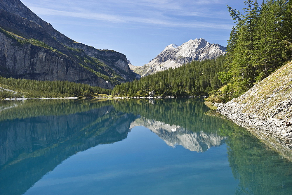 Reflection of mountains on lake Oeschinensee, Kandersteg, Bernese Oberland, Canton of Bern, Switzerland, Europe