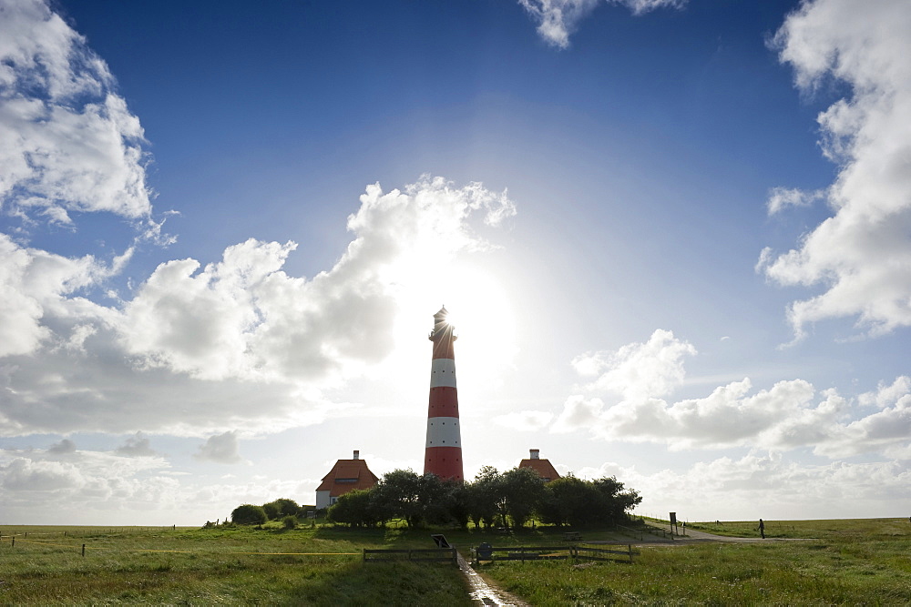 Backlit Westerheversand lighthouse, Westerhever, Wadden Sea National Park, Eiderstedt peninsula, North Frisian Islands, Schleswig-Holstein, Germany, Europe