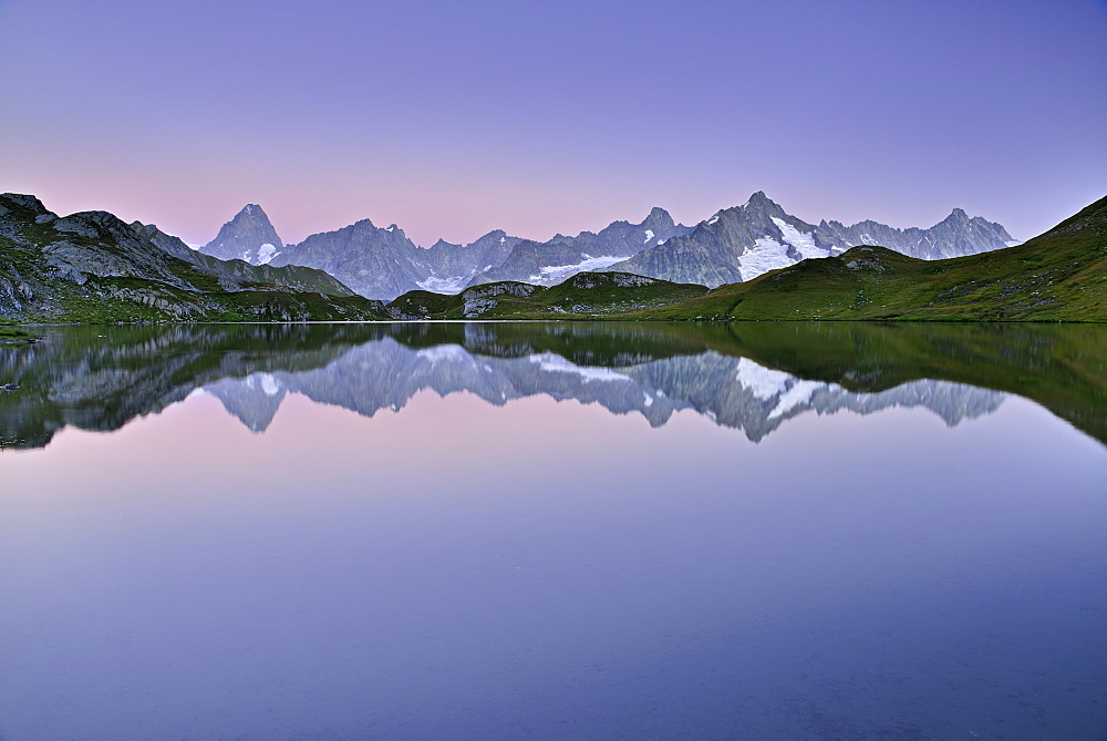 Mont Blanc range with Grandes Jorasses and Mont Dolent reflecting in a mountain lake, Pennine Alps, Aosta valley, Italy