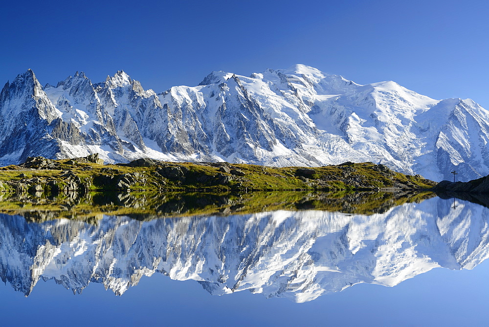 Mont Blanc range with Aiguilles du Chamonix and Mont Blanc reflecting in a mountain lake, Mont blanc range, Chamonix, Savoy, France