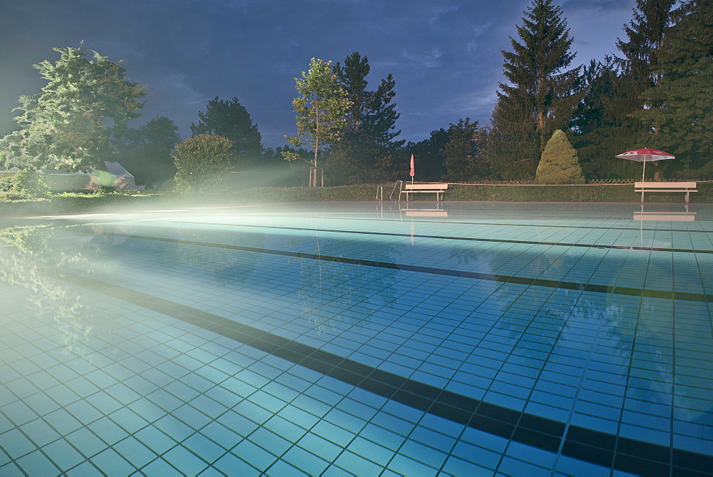 Fog at water surface at open air swimming pool Spiesel, Aalen, Ostalbkreis, Swabian Alb, Baden-Wuerttemberg, Germany