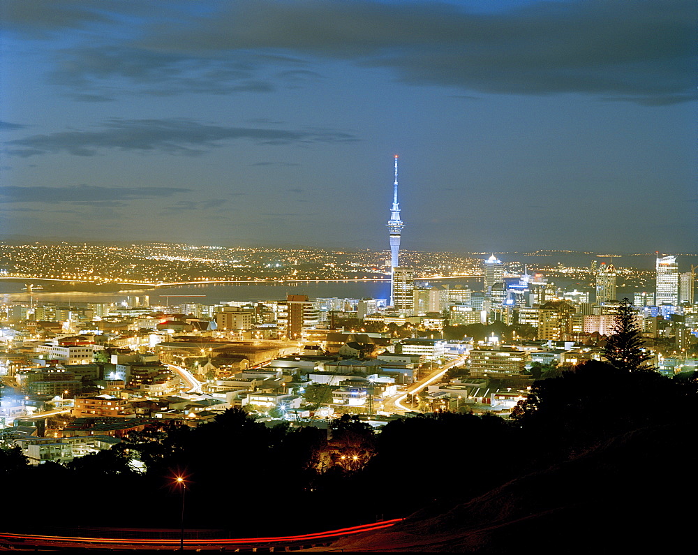 View at the illuminated Central Business District with Sky Tower at night, Auckland, North Island, New Zealand