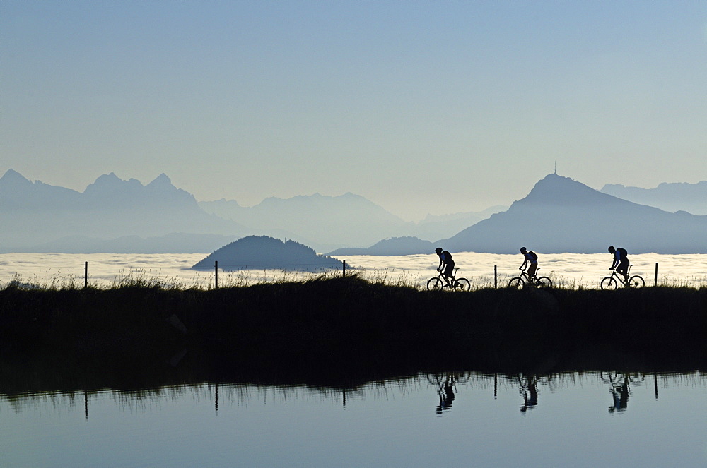 Mountain bikers at Lake Salvensee, Hohe Salve, Kitzbuehel Horn, Kitzbuehel Alps, Tyrol, Austria