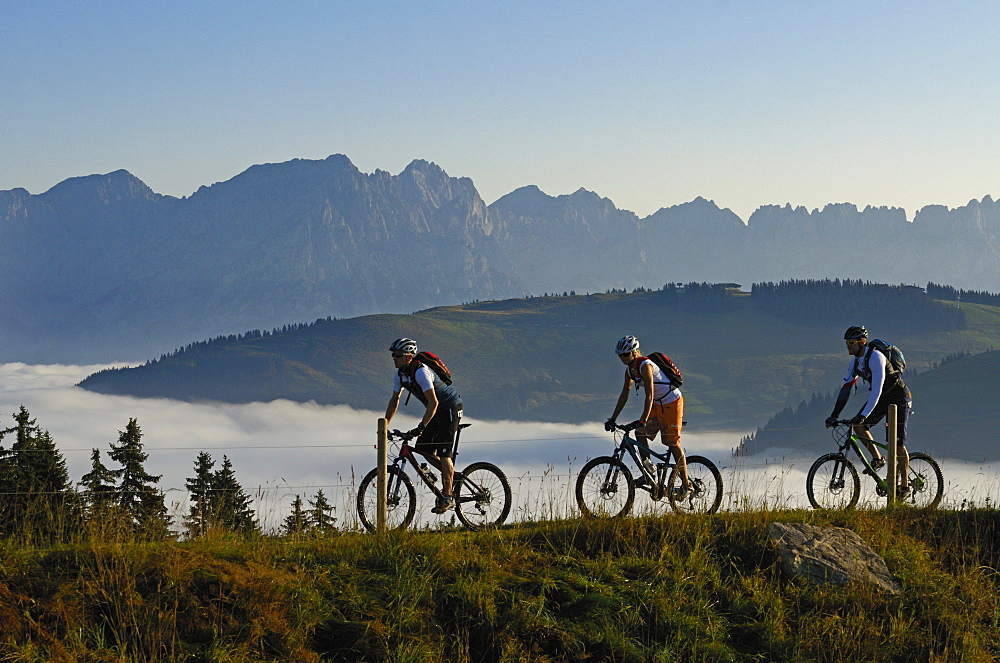 Mountain bikers at Lake Salvensee, Hohe Salve, Kitzbuehel Horn, Kitzbuehel Alps, Tyrol, Austria