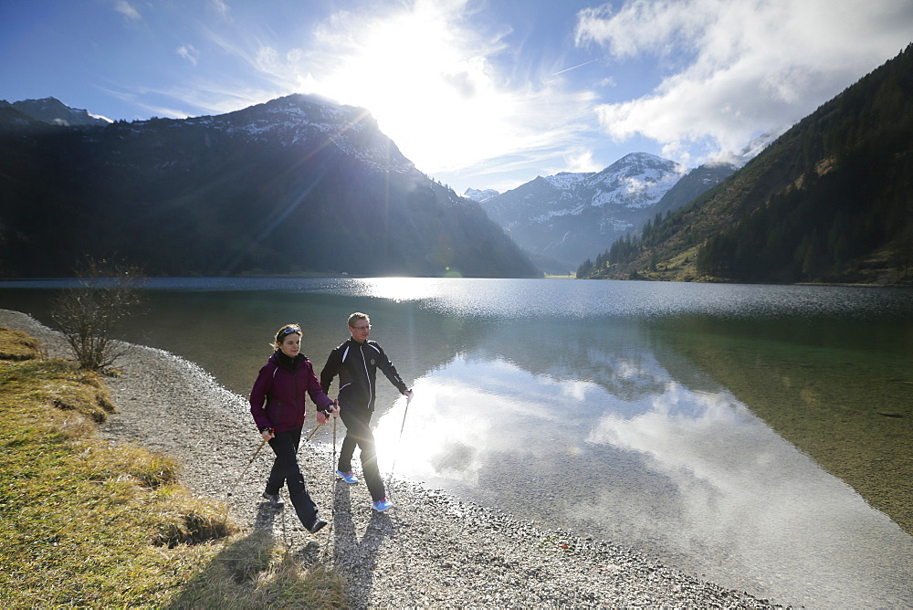 Two Nordic Walkers at lake Vilsalpsee, Tannheim, Tannheim Valley, Tyrol, Austria