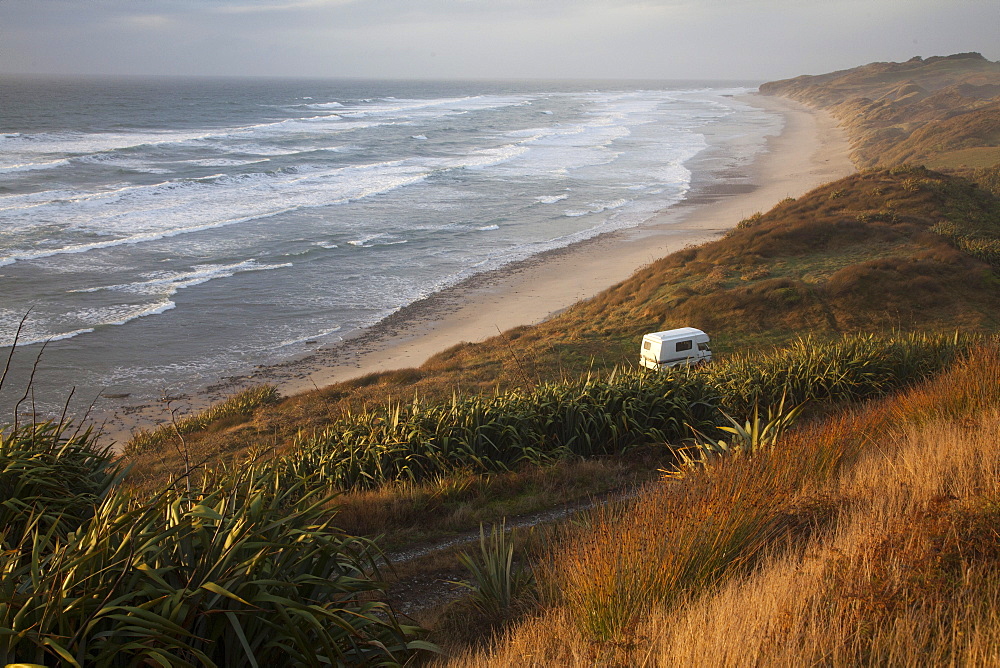 Camper van parked on a secluded beach along the West coast, South Island, New Zealand